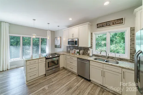 a kitchen with a sink stove top oven and cabinets