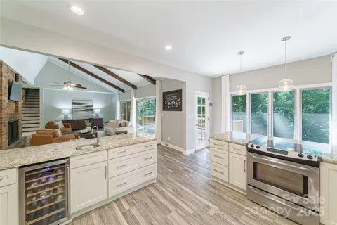 a kitchen with sink stove and cabinets