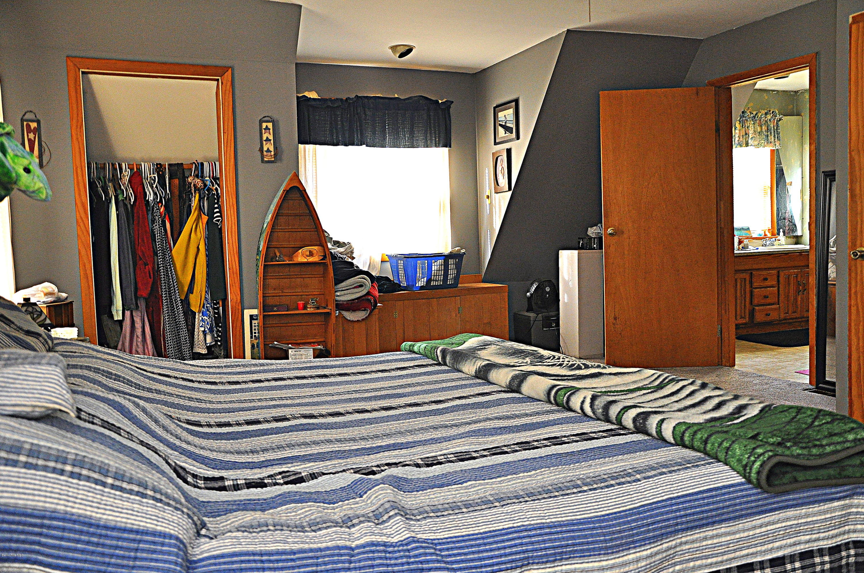 363 North Main Road Otis, MA 01253 - Photo 22 of 27 a view of walk in closet with clothes and shoes