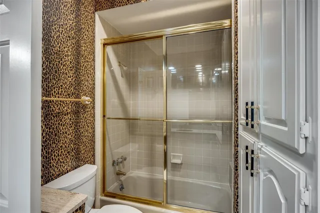 a bathroom with a glass shower door