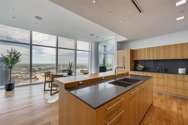 a kitchen with a table chairs stove and cabinets