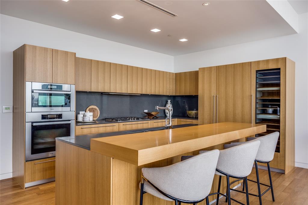 1918 Olive Street, Unit 3601 Dallas, TX 75201 - Photo 13 of 39 a kitchen with a table chairs stove and cabinets