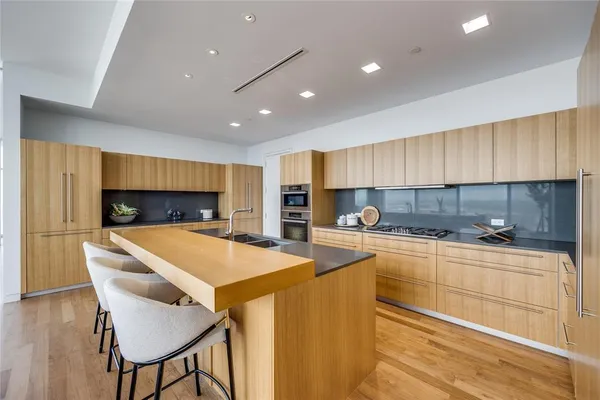 a kitchen with stainless steel appliances a stove sink and cabinets
