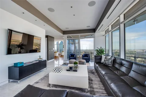 a bedroom with a bed and glass walk in closet