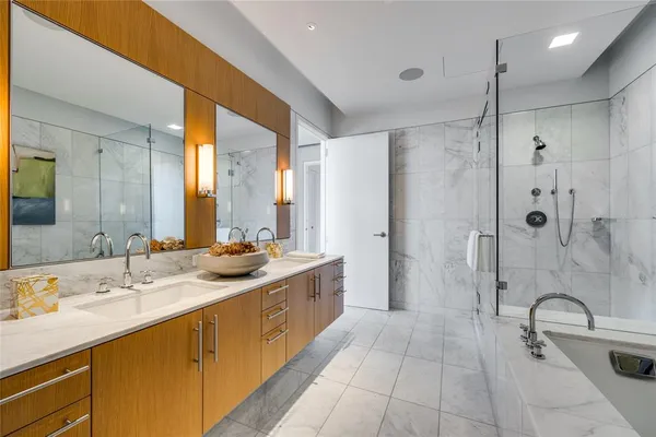 a bathroom with a tub a sink and shower