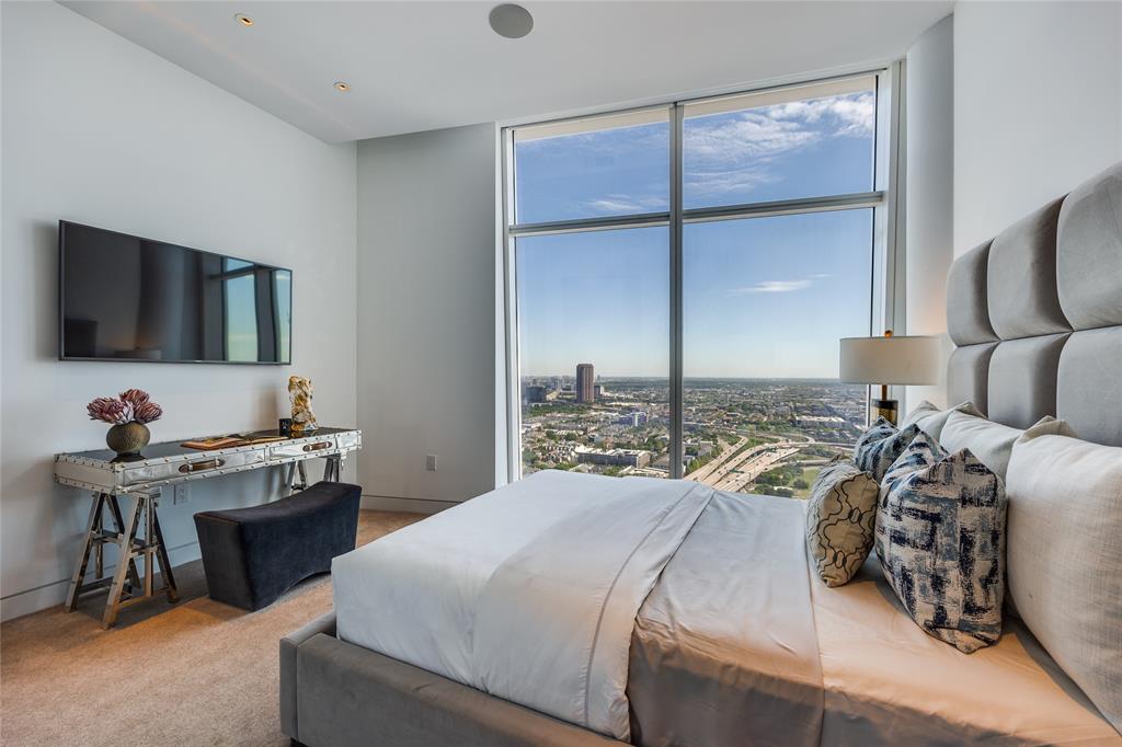 1918 Olive Street, Unit 3601 Dallas, TX 75201 - Photo 28 of 39 a bedroom with a bed and a flat screen tv