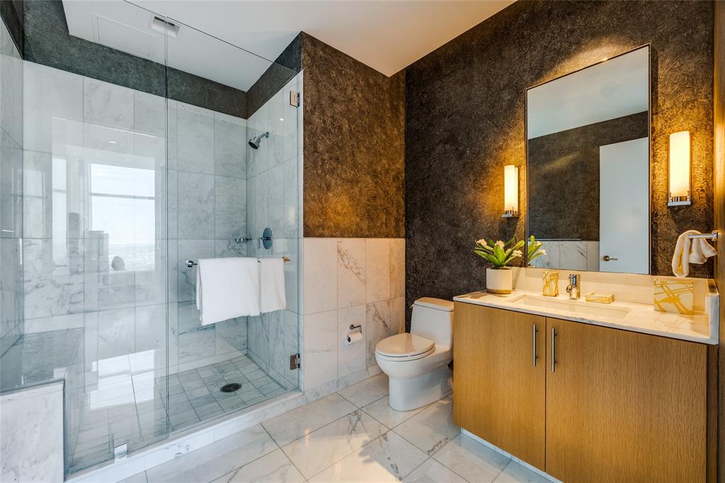 1918 Olive Street, Unit 3601 Dallas, TX 75201 - Photo 29 of 39 a bathroom with a sink toilet a mirror and shower