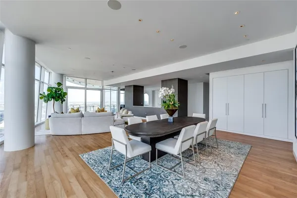 a kitchen with a dining table chairs and view living room