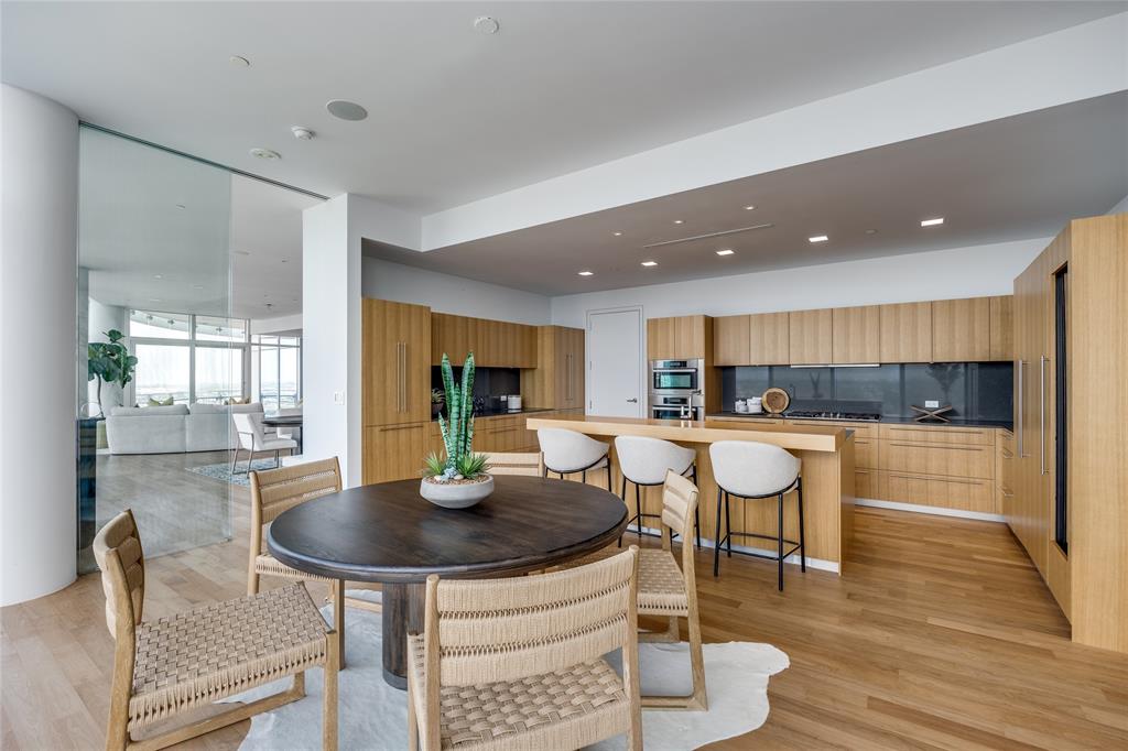 1918 Olive Street, Unit 3601 Dallas, TX 75201 - Photo 10 of 39 a kitchen with a dining table chairs and view living room
