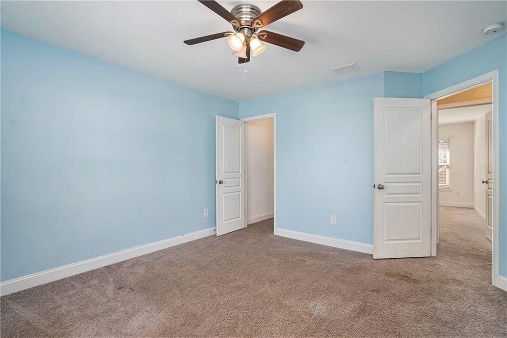 115 Floating Leaf Way Dallas, GA 30132 - Photo 25 of 47 an empty room with closet and a chandelier fan