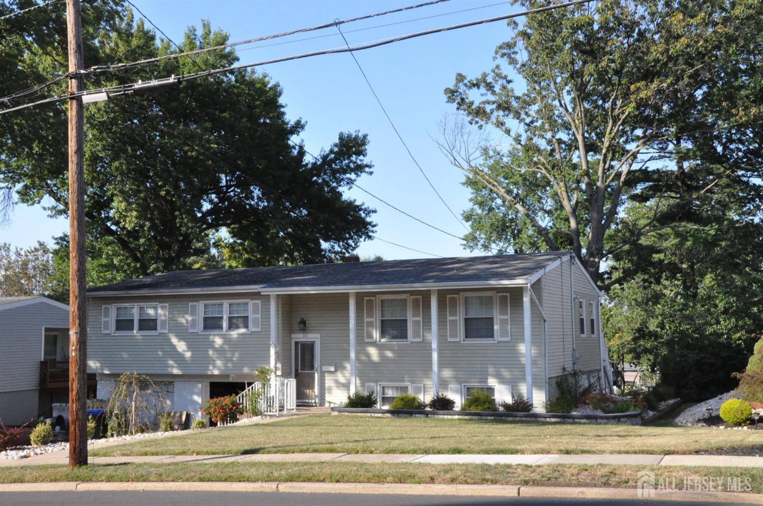 32 Harmon Road Edison, NJ 08837 - Photo 1 of 52 a front view of a house with a yard table and chairs