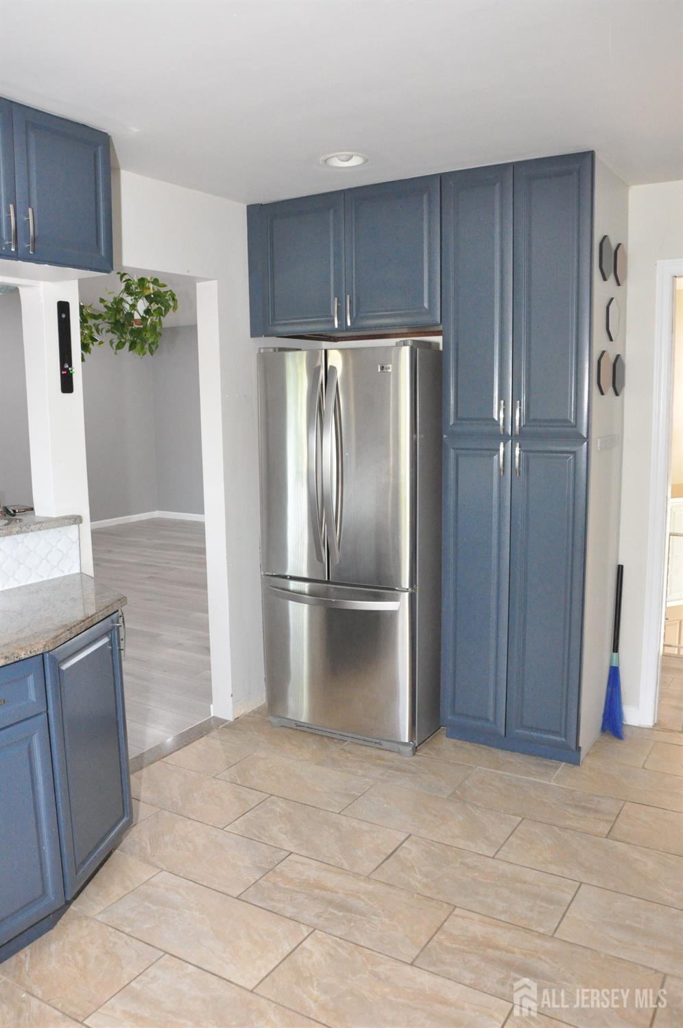 32 Harmon Road Edison, NJ 08837 - Photo 14 of 52 a metallic refrigerator freezer sitting in a kitchen