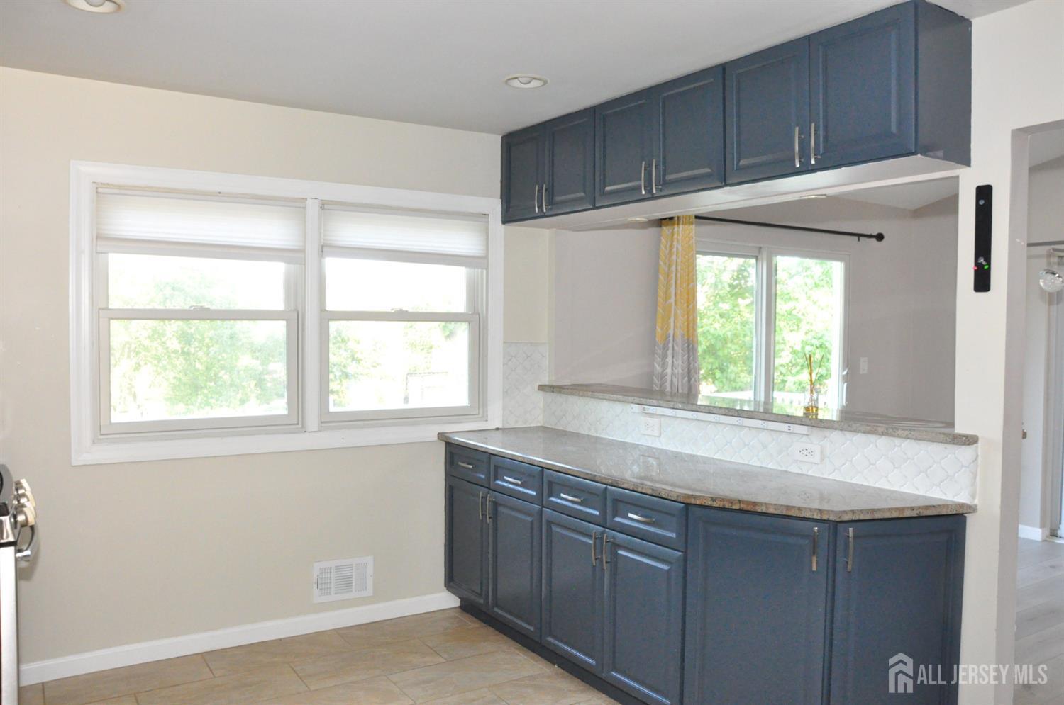 32 Harmon Road Edison, NJ 08837 - Photo 15 of 52 a kitchen with granite countertop cabinets stainless steel appliances and a window