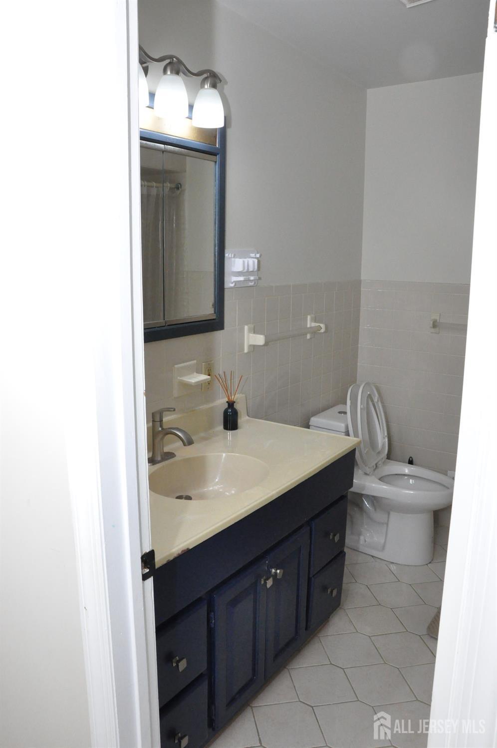 32 Harmon Road Edison, NJ 08837 - Photo 20 of 52 a bathroom with a sink and a mirror