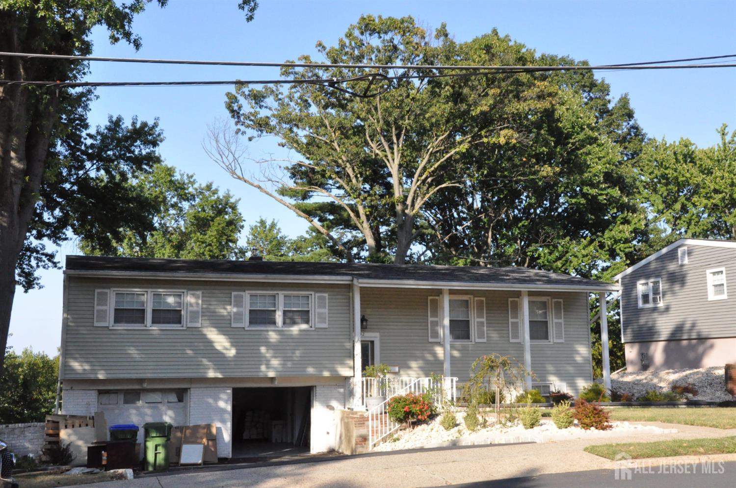 32 Harmon Road Edison, NJ 08837 - Photo 2 of 52 a front view of a house with a garden