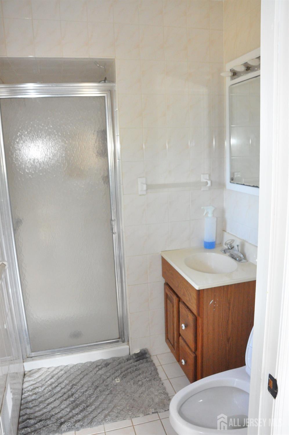 32 Harmon Road Edison, NJ 08837 - Photo 24 of 52 a bathroom with a granite countertop sink toilet and shower