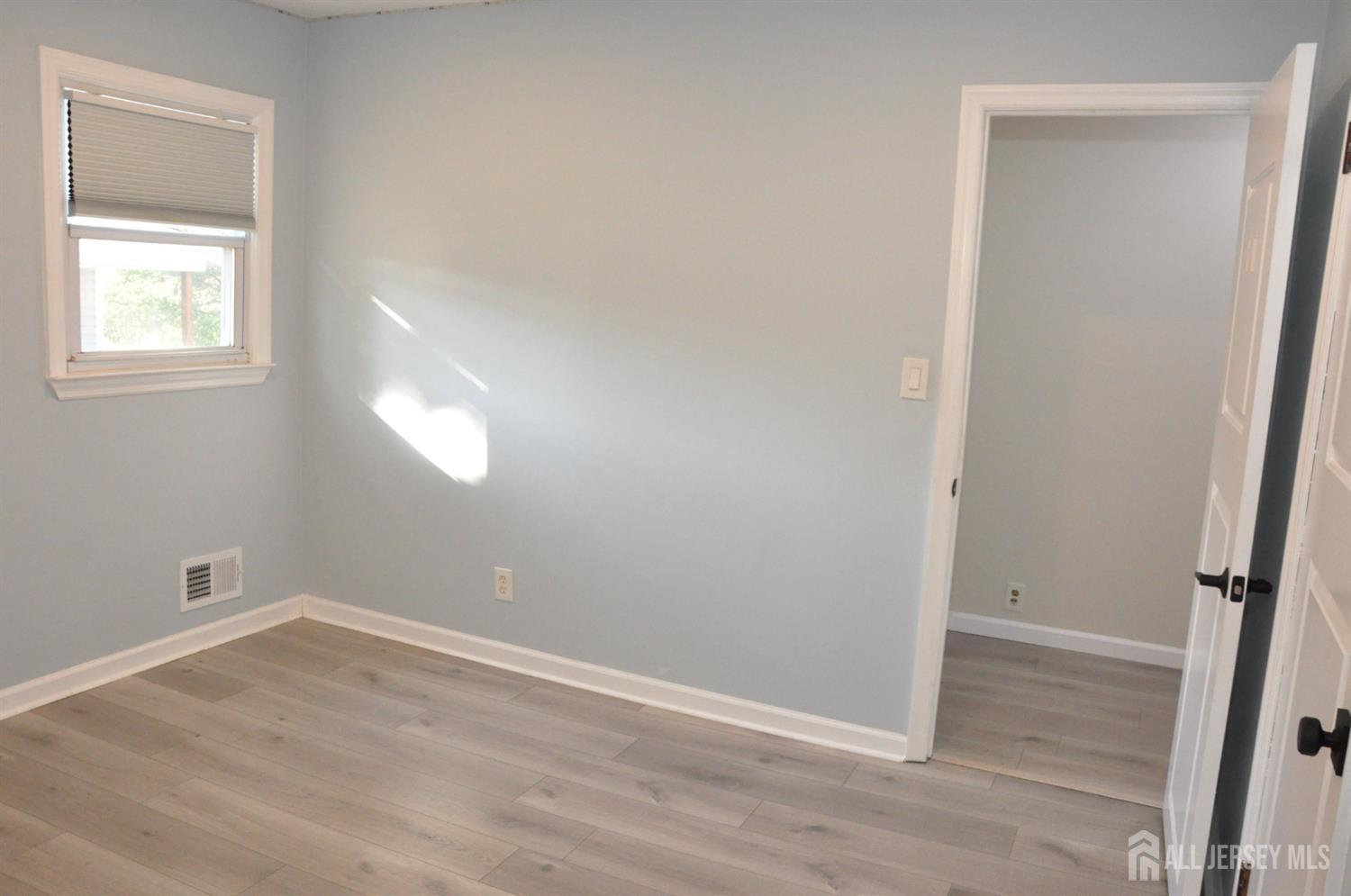 32 Harmon Road Edison, NJ 08837 - Photo 25 of 52 an empty room with wooden floor and windows