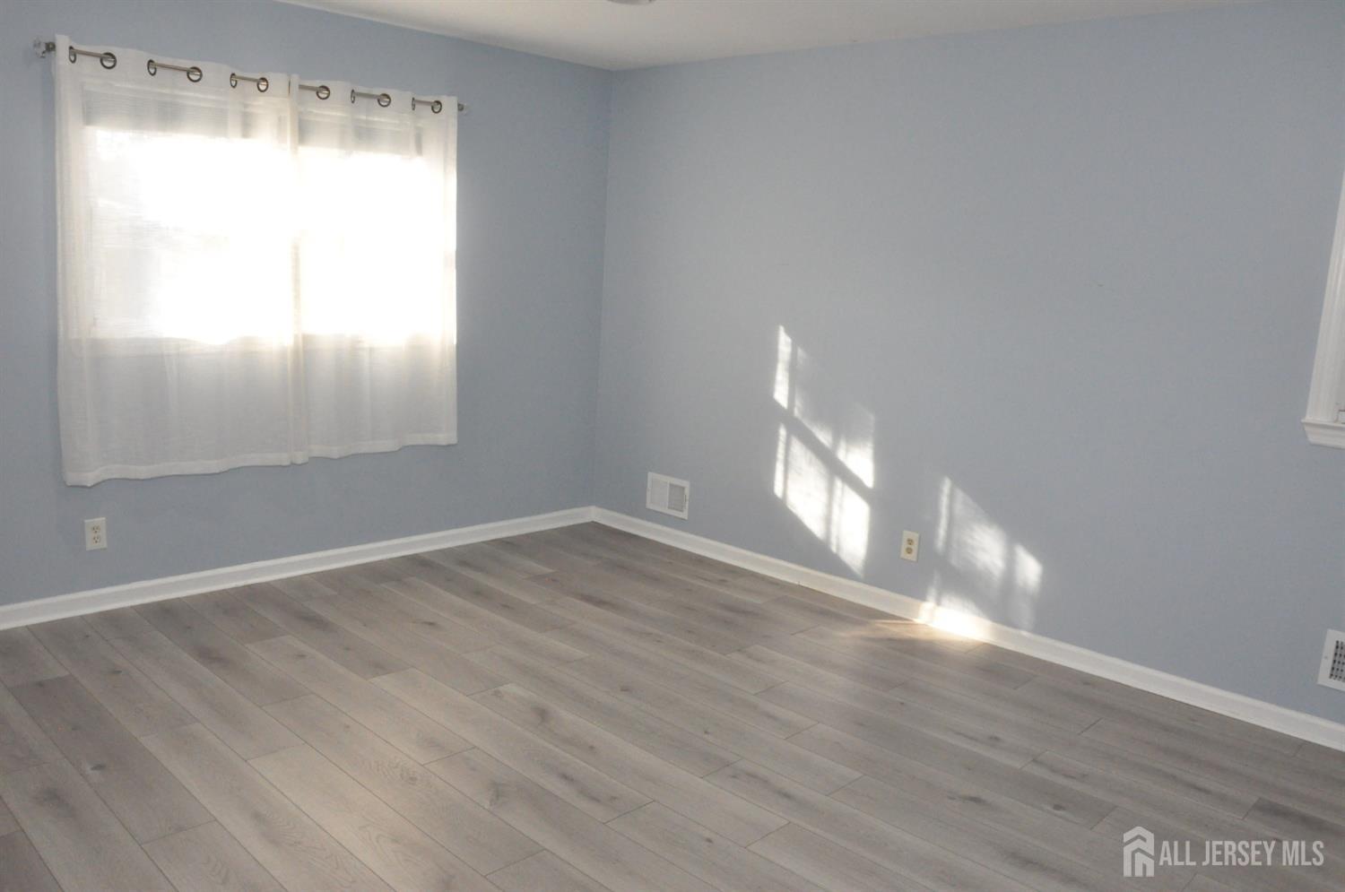32 Harmon Road Edison, NJ 08837 - Photo 29 of 52 a view of empty room with wooden floor and fan