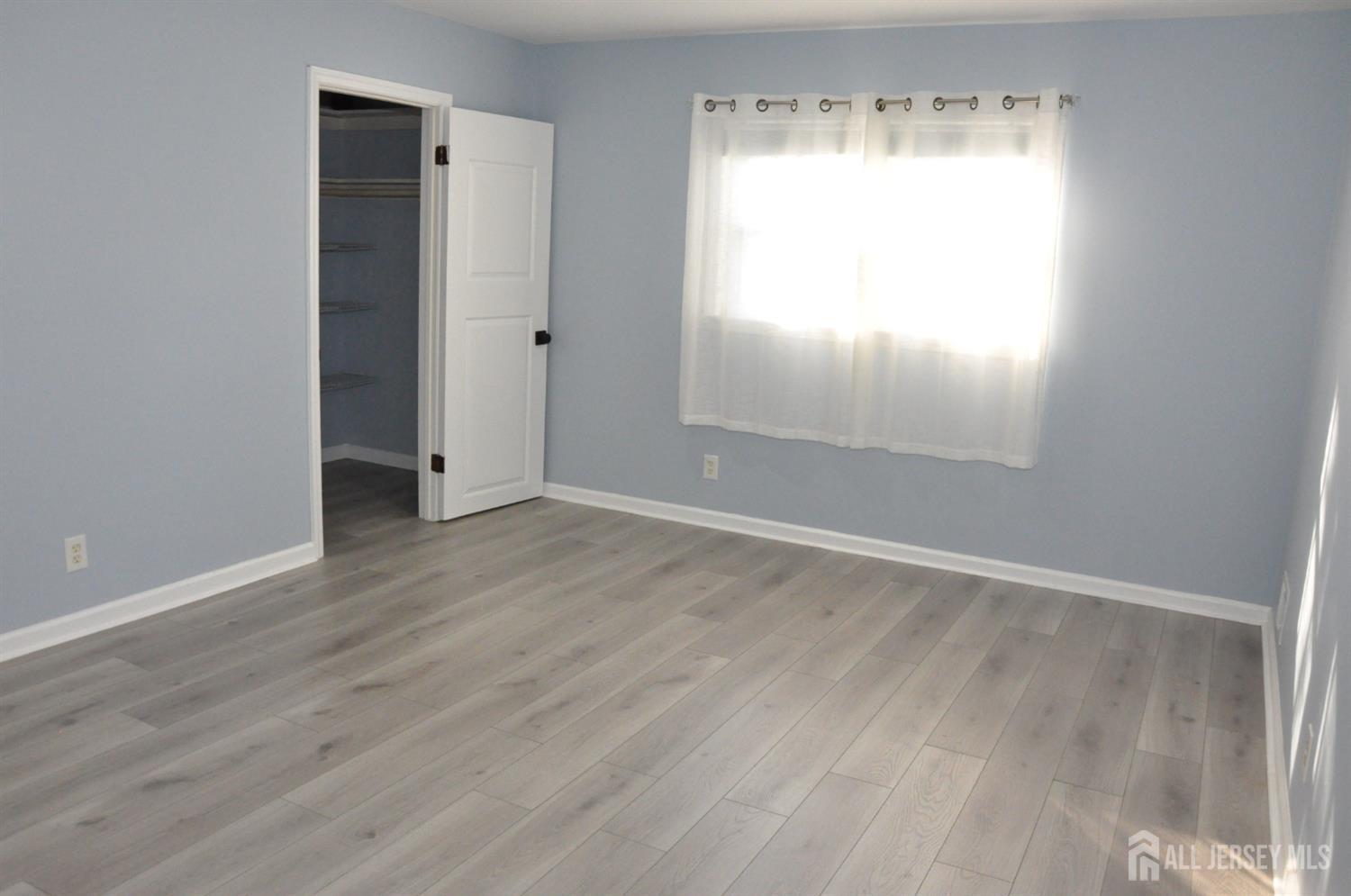 32 Harmon Road Edison, NJ 08837 - Photo 30 of 52 an empty room with wooden floor and windows