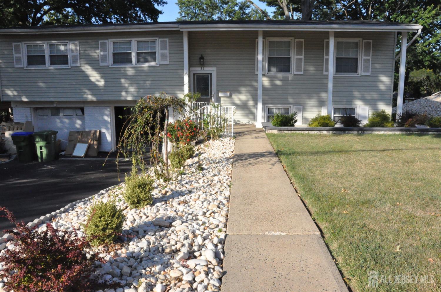 32 Harmon Road Edison, NJ 08837 - Photo 3 of 52 a front view of a house with garden