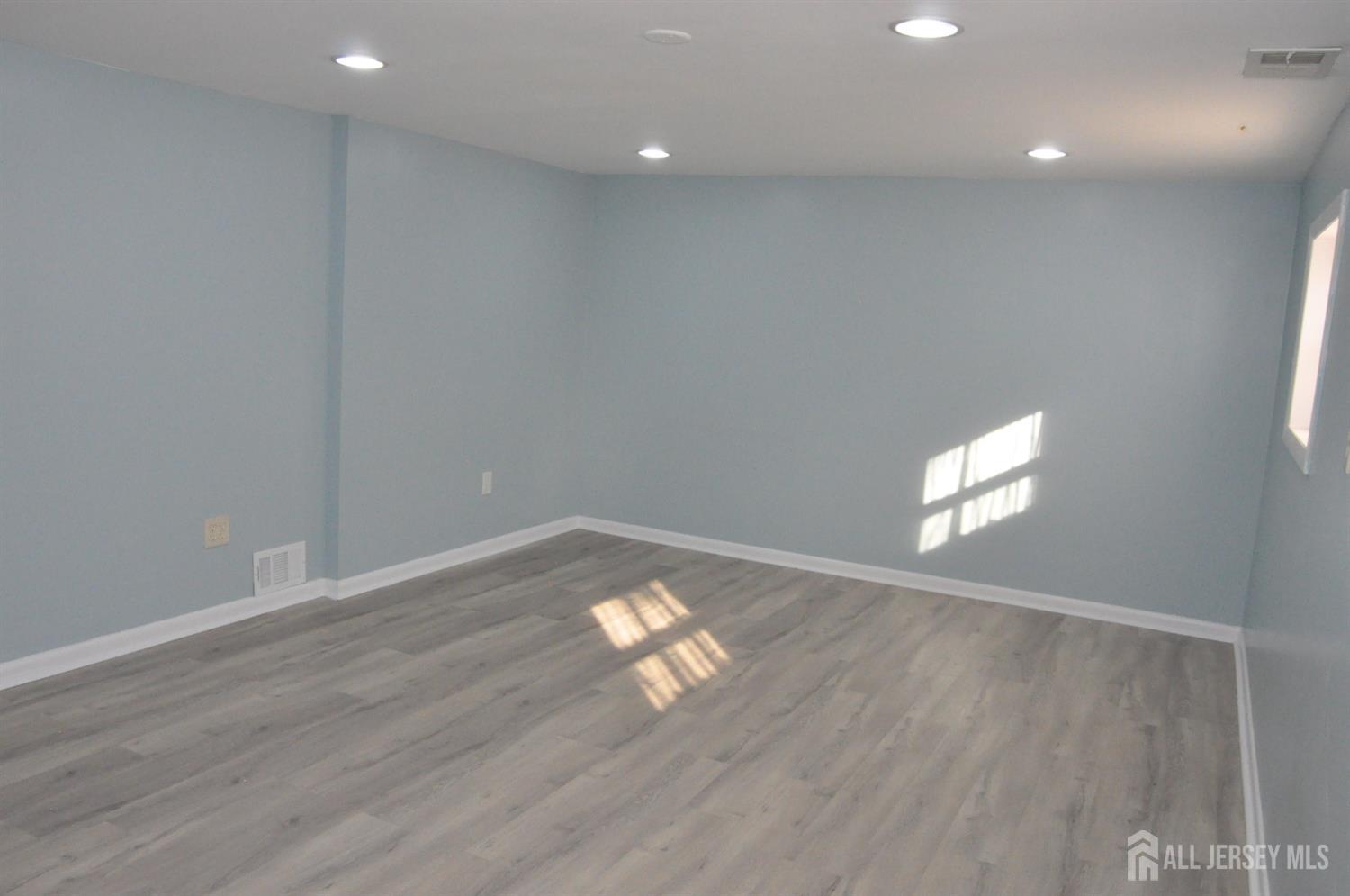 32 Harmon Road Edison, NJ 08837 - Photo 35 of 52 an empty room with wooden floor and windows