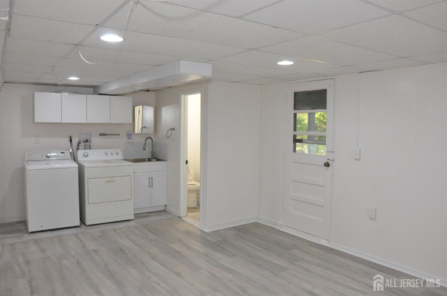 32 Harmon Road Edison, NJ 08837 - Photo 38 of 52 a view of a kitchen with white cabinets and wooden floor