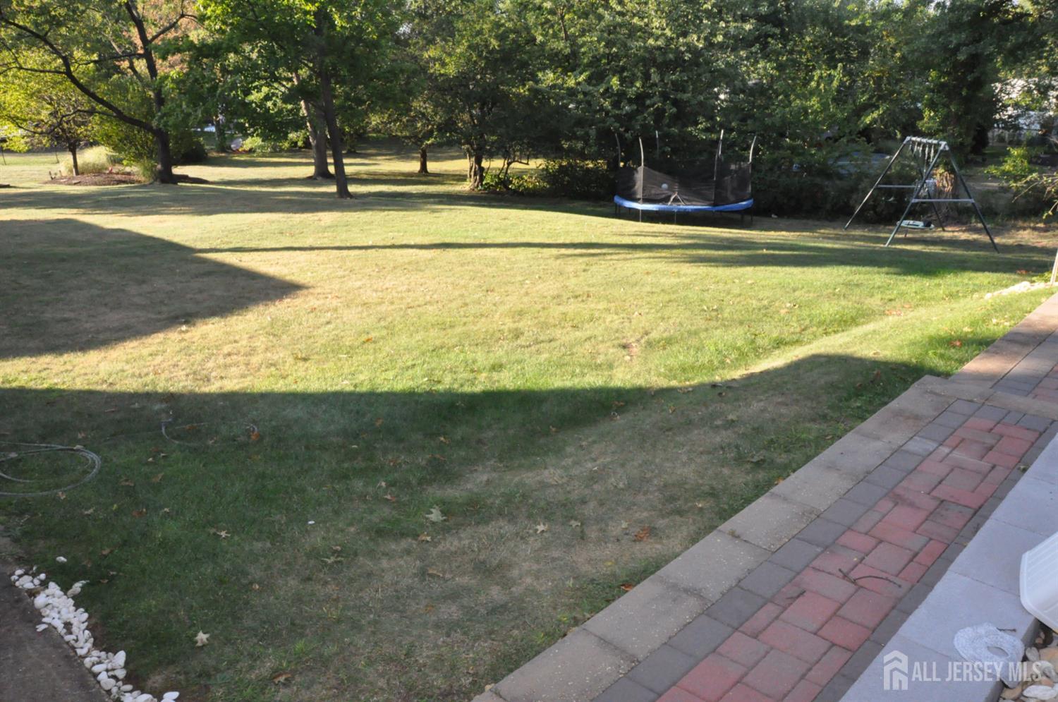 32 Harmon Road Edison, NJ 08837 - Photo 46 of 52 a view of swimming pool with outdoor seating and trees in the background