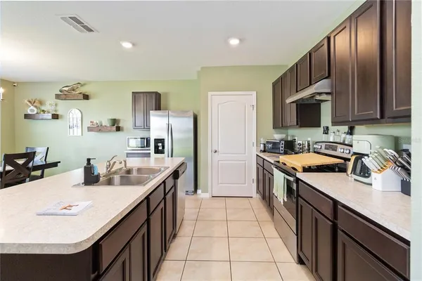 a kitchen with a sink stove and cabinets