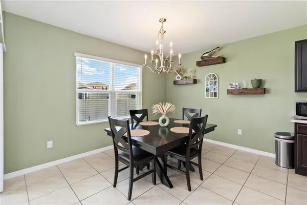 a view of a dining room with furniture and chandelier