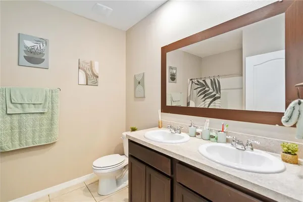 a bathroom with a granite countertop sink mirror and toilet