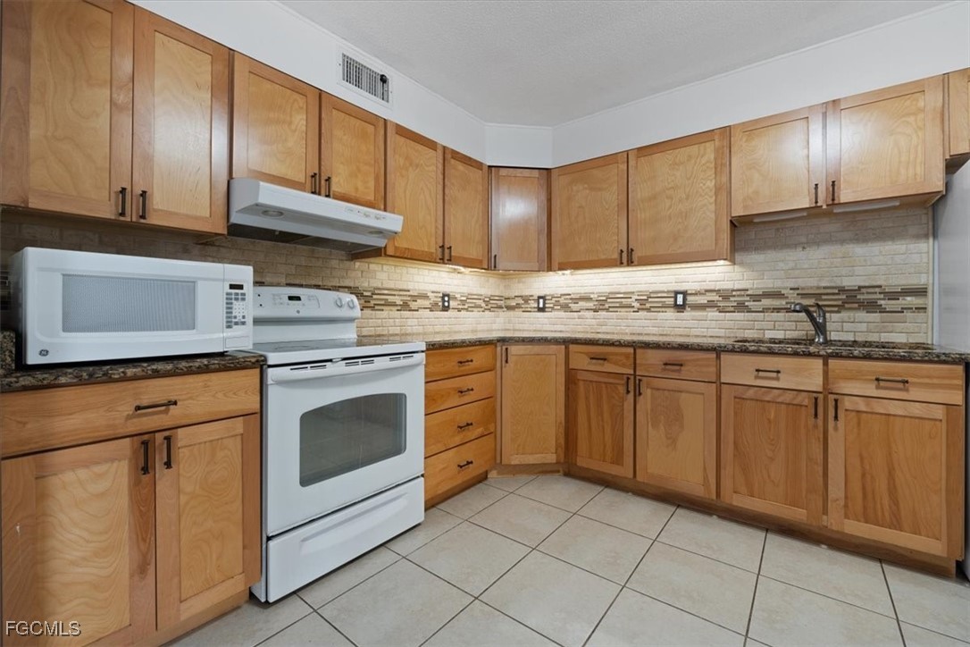 610 East Avenida Del Rio Clewiston, FL 33440 - Photo 12 of 49 a kitchen with cabinets appliances and a sink