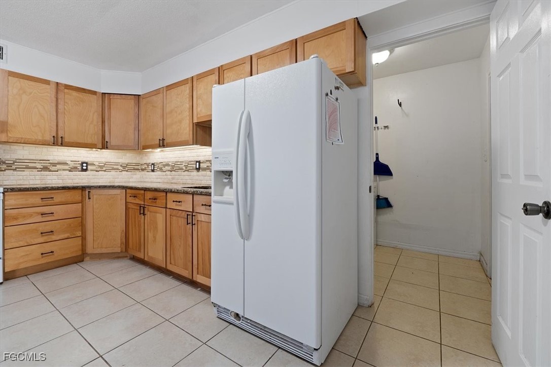 610 East Avenida Del Rio Clewiston, FL 33440 - Photo 16 of 49 a kitchen with a refrigerator sink and cabinets