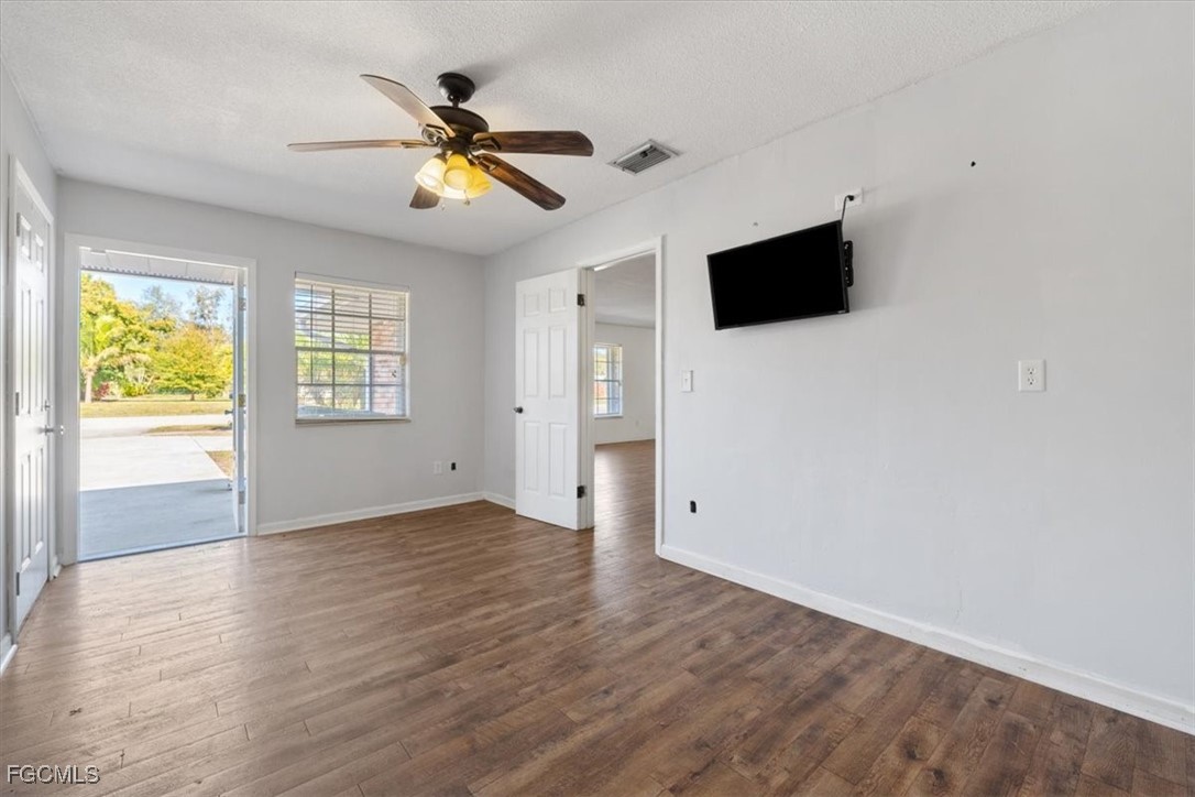 610 East Avenida Del Rio Clewiston, FL 33440 - Photo 19 of 49 a view of an empty room with a window and wooden floor