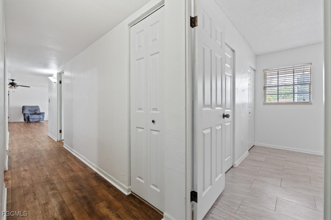 610 East Avenida Del Rio Clewiston, FL 33440 - Photo 25 of 49 a view of a hallway with wooden floor and a bathroom