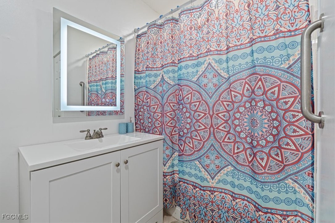 610 East Avenida Del Rio Clewiston, FL 33440 - Photo 30 of 49 a bathroom with a sink and a mirror