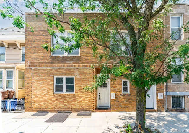 a front view of a house with tree s