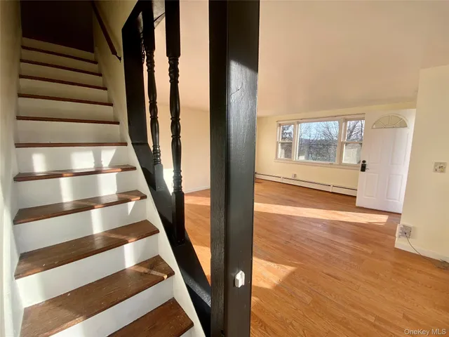 a view of a hallway with wooden floor