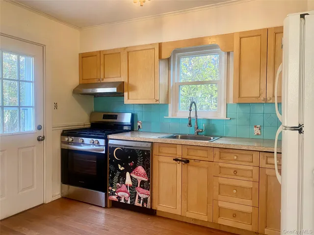 a kitchen with stainless steel appliances a refrigerator and a stove top oven