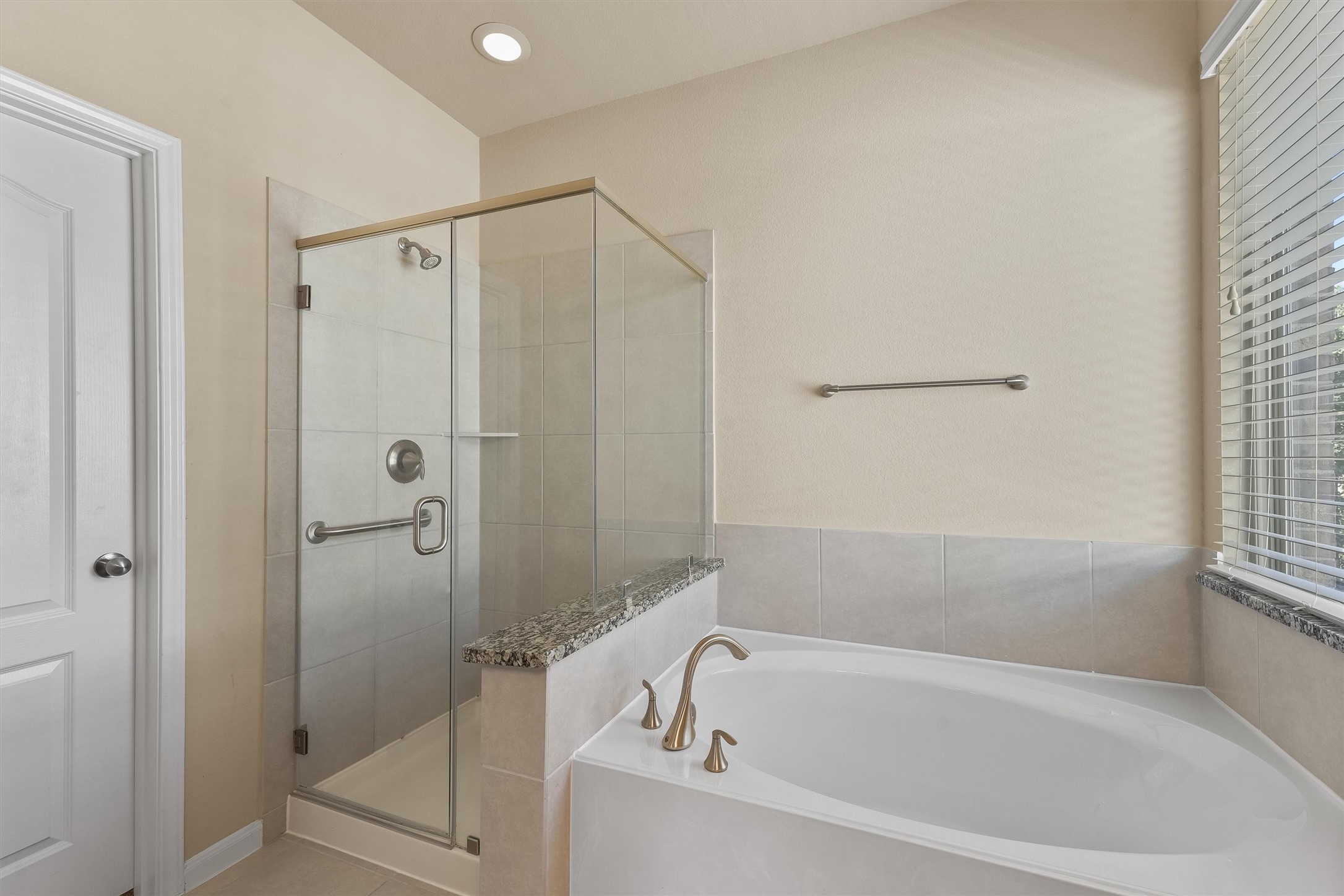 3841 Enchanted Timbers Lane Spring, TX 77386 - Photo 15 of 28 a bathroom with a bathtub and a shower