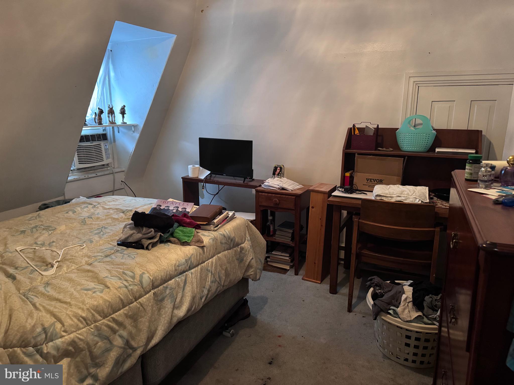 1128 North 6th Street Reading, PA 19601 - Photo 17 of 19 a bedroom with a bed and a computer on a desk