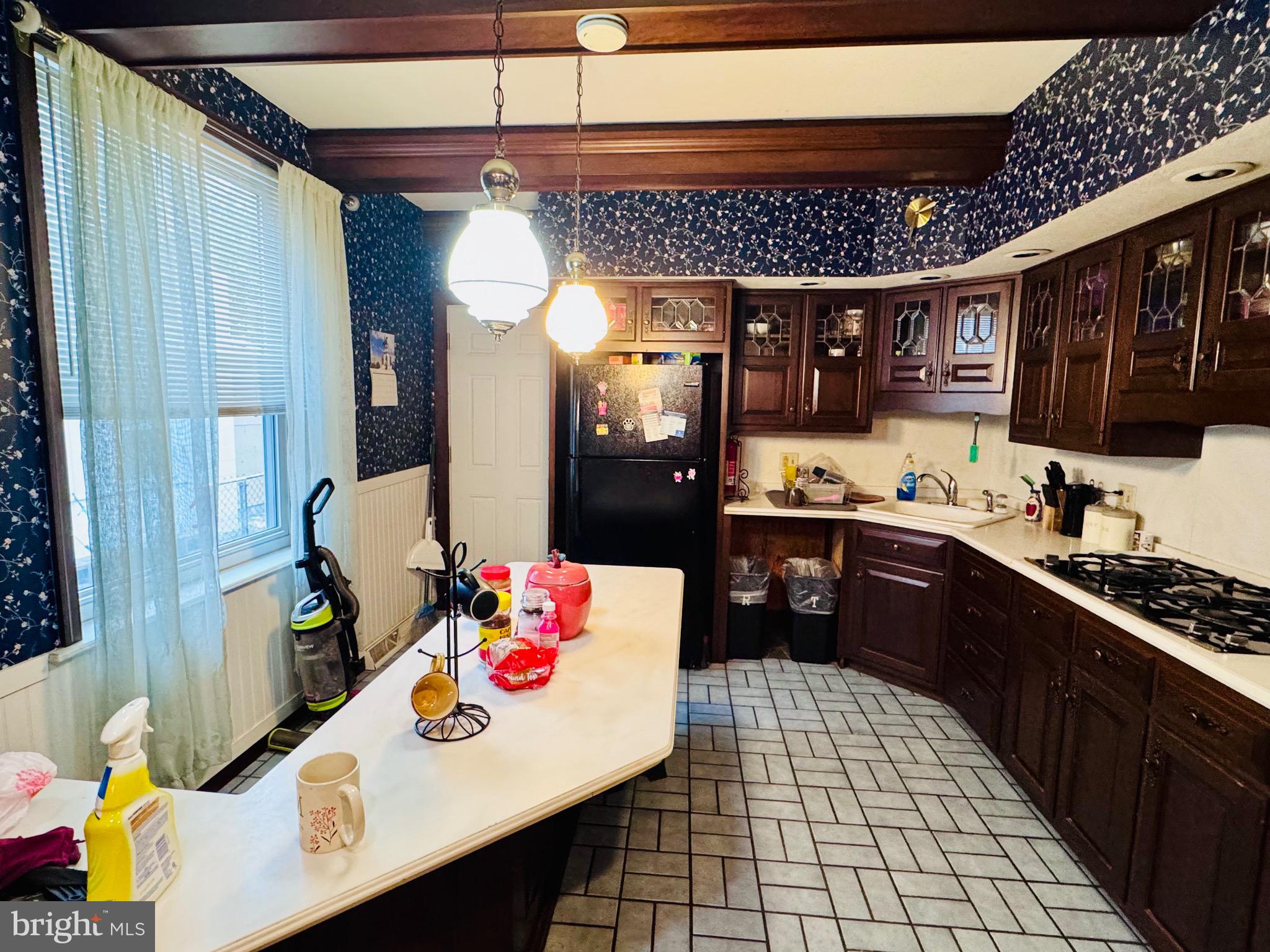 1128 North 6th Street Reading, PA 19601 - Photo 9 of 19 a kitchen with stainless steel appliances granite countertop a sink and cabinets