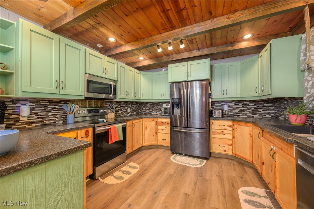 33201 Host Road Bowerston, OH 44695 - Photo 7 of 30 Kitchen featuring stainless steel appliances, light hardwood / wood-style floors, beamed ceiling, and tasteful backsplash