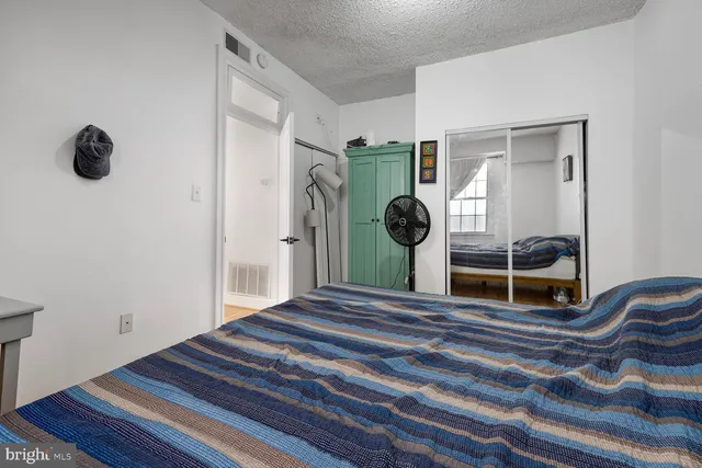 a bedroom with a bed and a cabinets