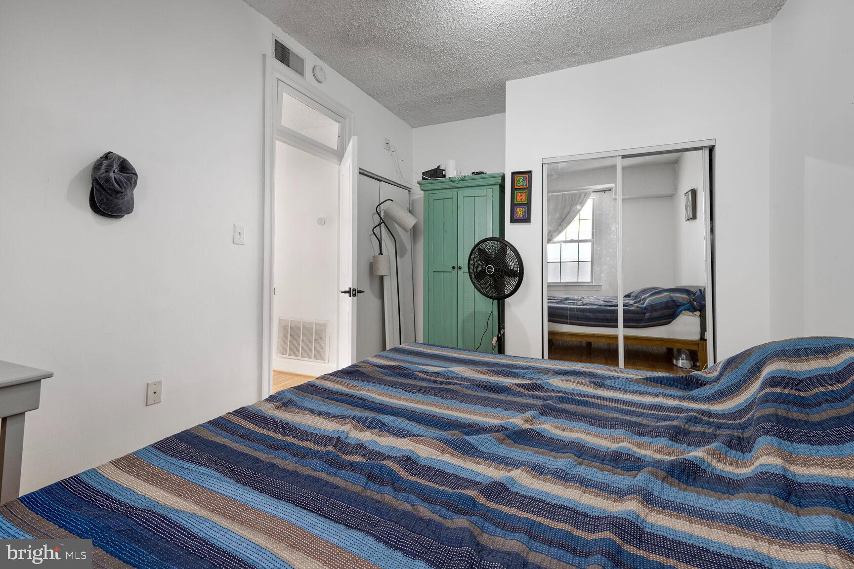 1401 Columbia Road Northwest, Unit 213 Washington, DC 20009 - Photo 11 of 14 a bedroom with a bed and a cabinets
