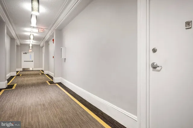 a room with a walk in closet and wooden floor