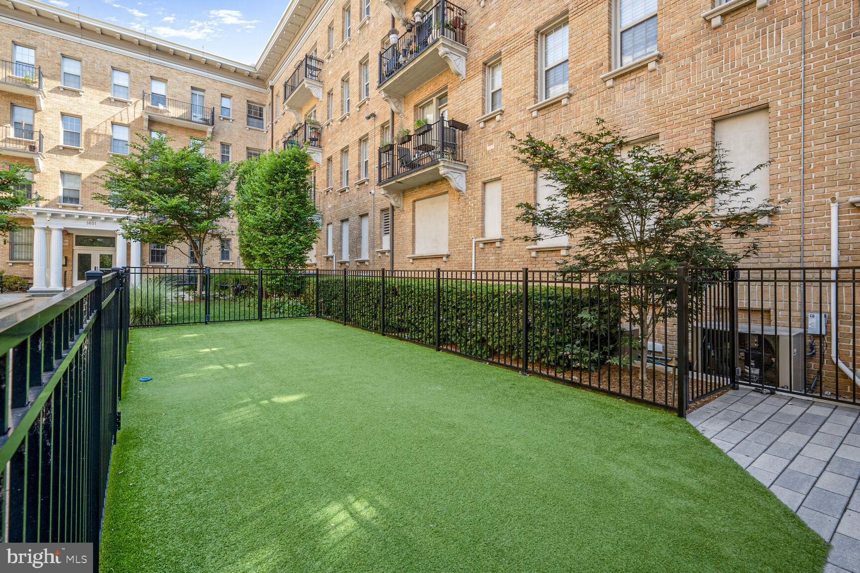 1401 Columbia Road Northwest, Unit 213 Washington, DC 20009 - Photo 2 of 14 a view of a house with a yard and sitting area