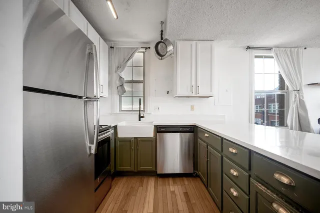 a kitchen with a sink a refrigerator and window