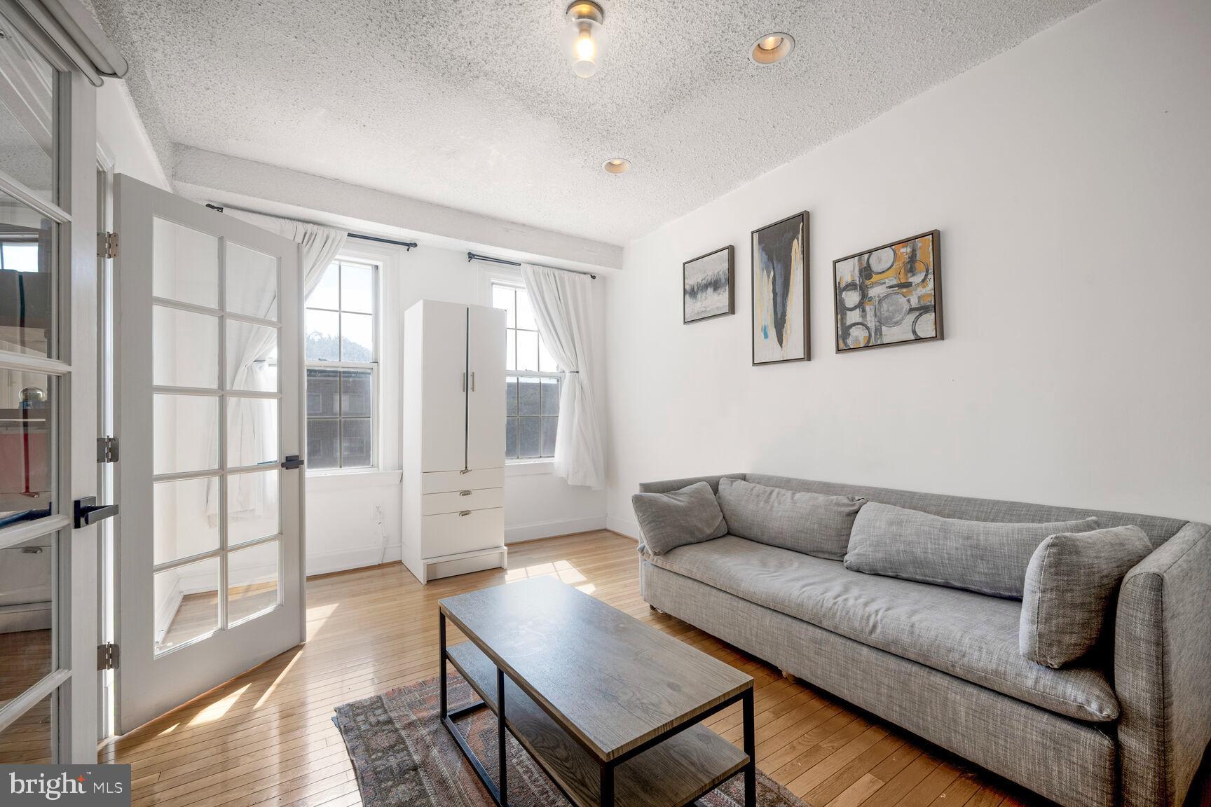 1401 Columbia Road Northwest, Unit 213 Washington, DC 20009 - Photo 8 of 14 a living room with furniture