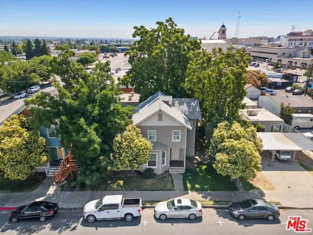 an aerial view of a house with a yard basket ball court and outdoor seating