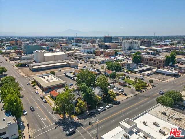 an aerial view of a house with a yard and a fountain
